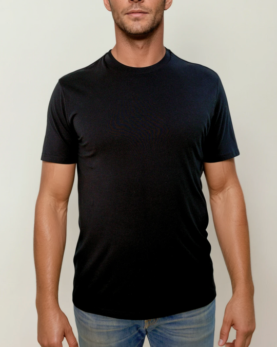The Ecotton Everyday Tee - Black color worn by a man paired with blue jeans against a neutral background. The image conveys a simple and casual fashion style.